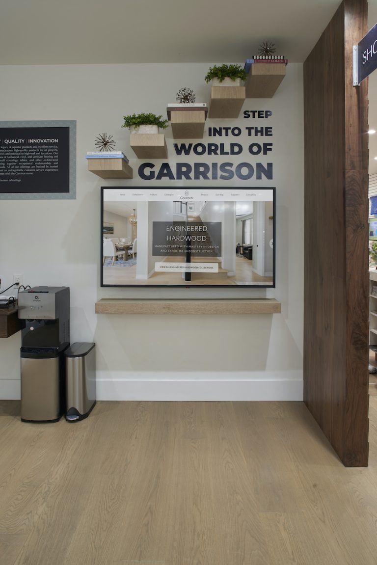 The Garrison Van Nuys showroom with flooring samples on the walls and a beautiful custom wooden floor