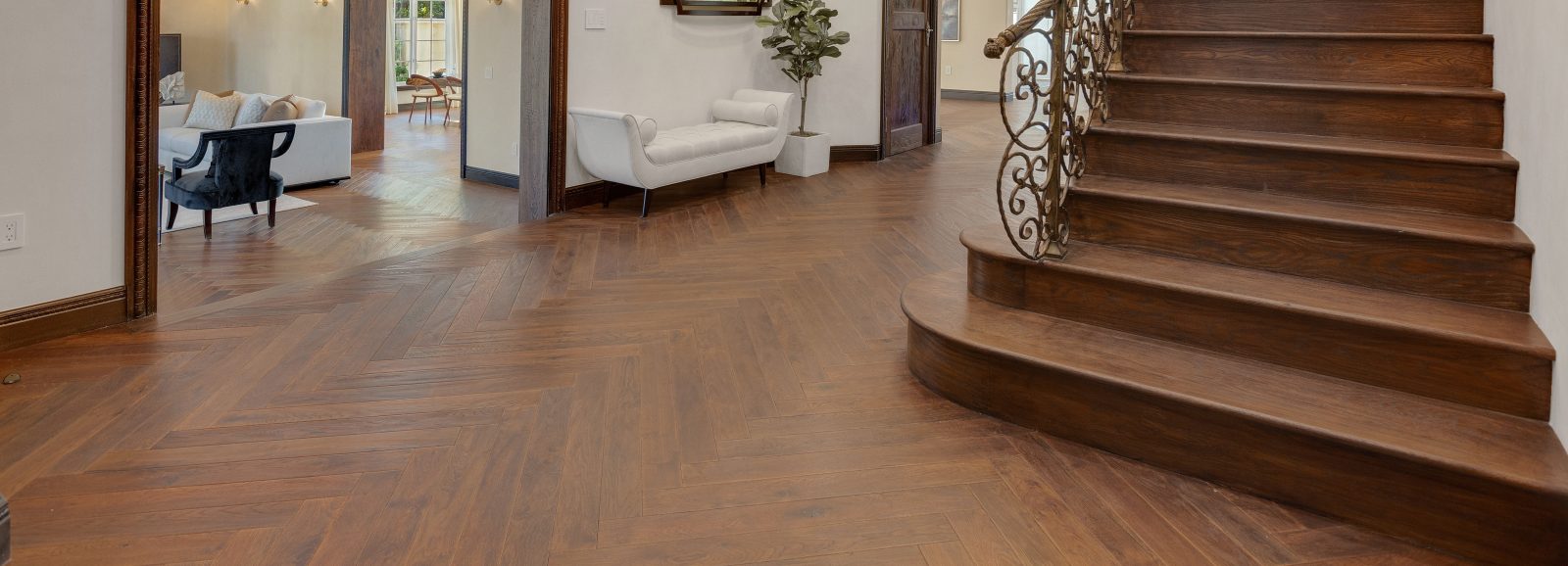 Brown Flooring hardwood in a foyer with a staircase